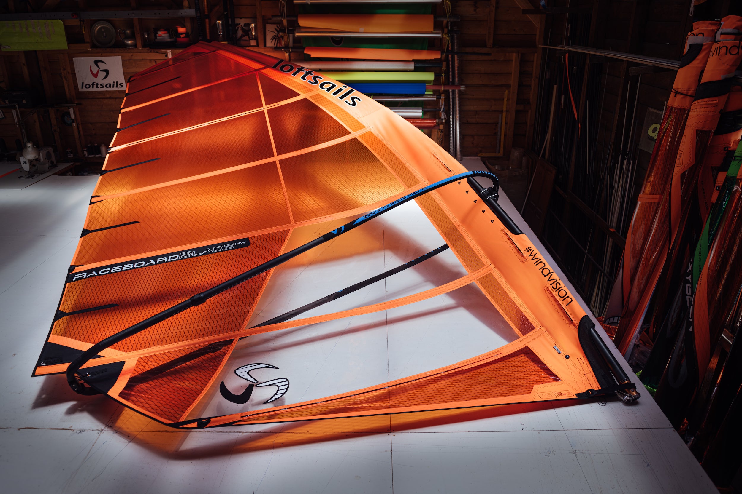 Orange sail with branding on a white floor in a warehouse setting